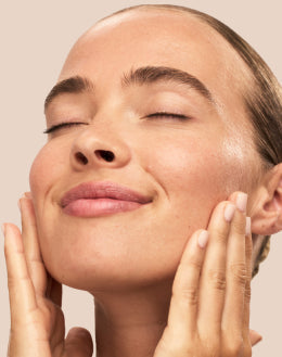 Treatment Serums and Essences Close-up of woman gently pressing hands on face during skincare treatment routine