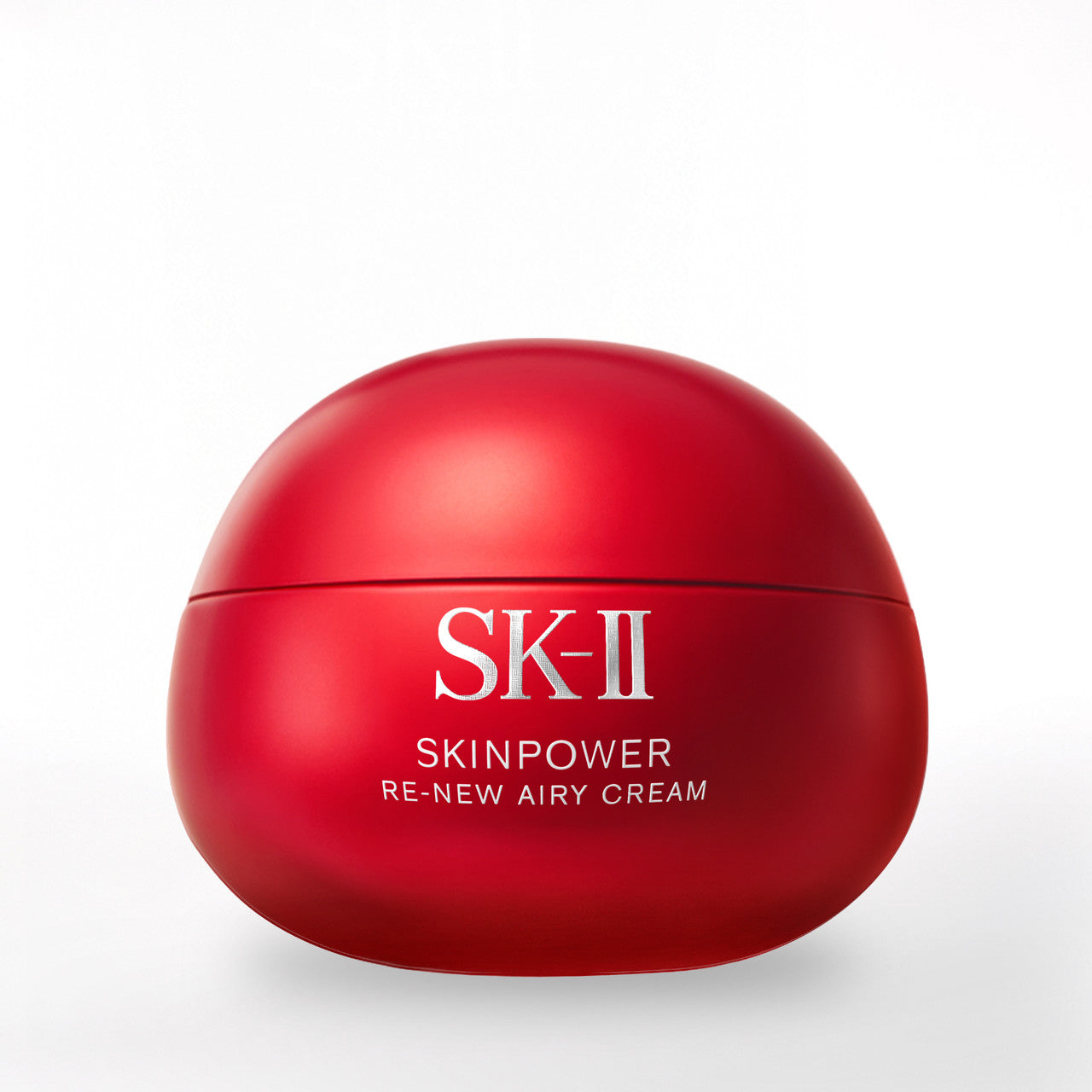 Close-up of SK-II SKINPOWER Re-New Airy Cream jar showing smooth red curved surface on a light background