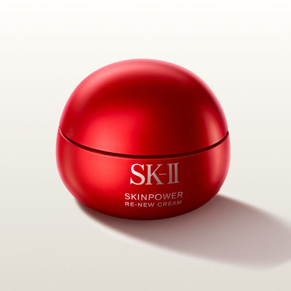 SK-II SKINPOWER Re-New Cream jar in red packaging placed on a light background with a soft shadow
