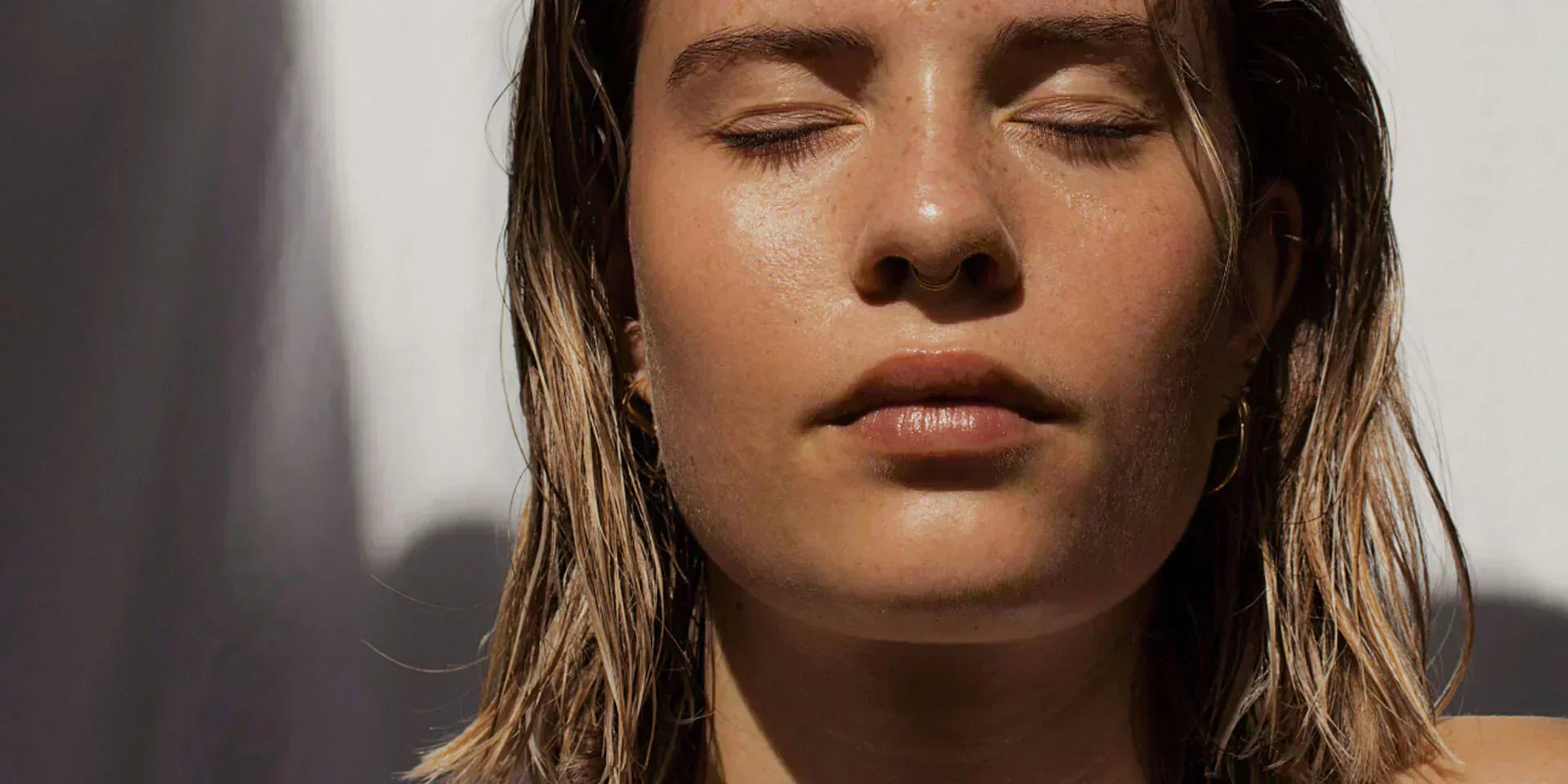 Close-up of woman's face with visible age spots on cheek area