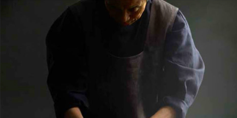 Hands mixing white grain material in a container during preparation process  