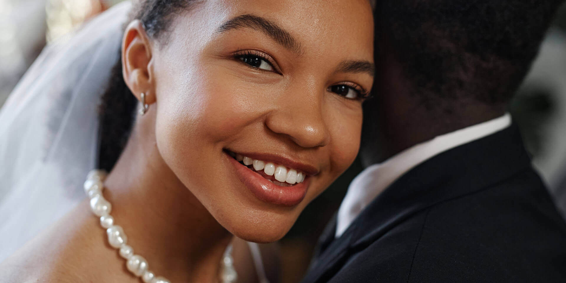 Close‑up portrait of a person with head slightly turned, showing natural skin surface in an indoor setting