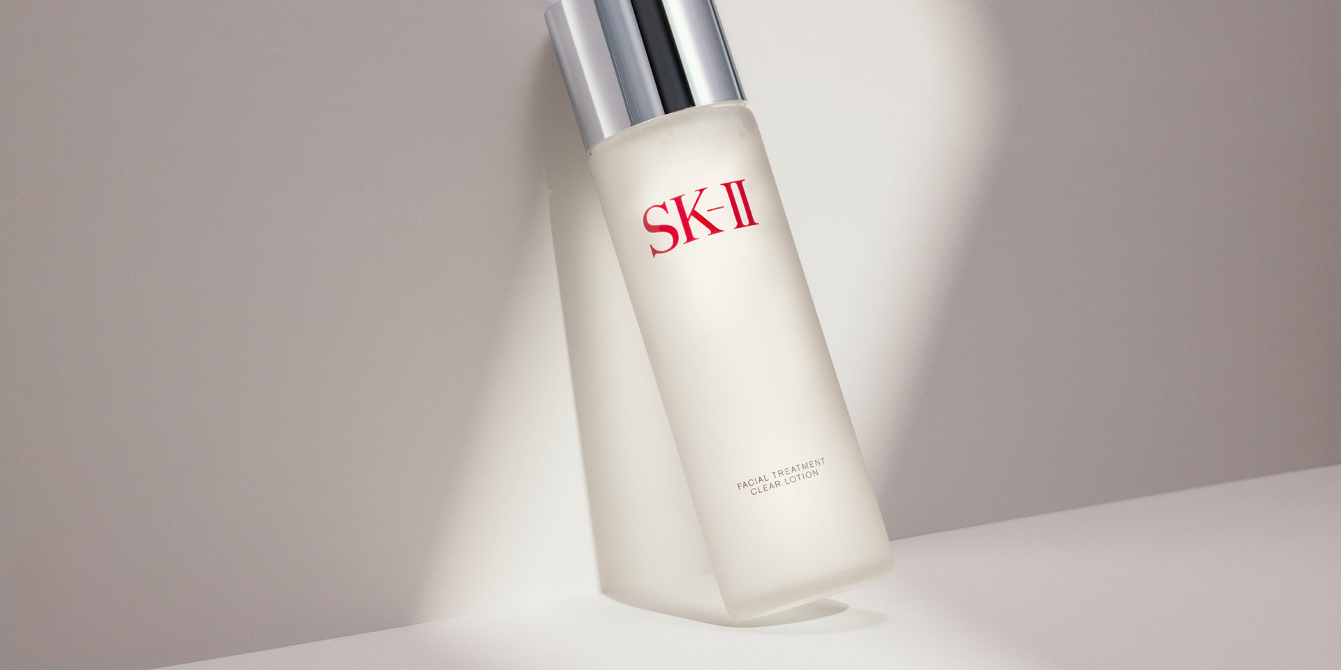 SK-II Facial Treatment Essence bottle placed on a light surface with soft shadow, representing winter skincare  