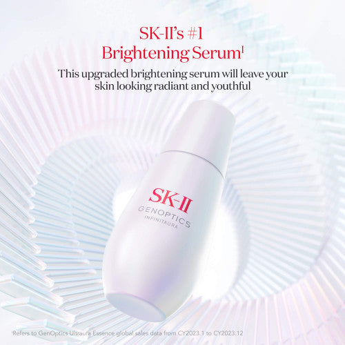 SK-II GenOptics Infinitaura Serum bottle placed on a circular textured surface with soft light reflections and gradient background