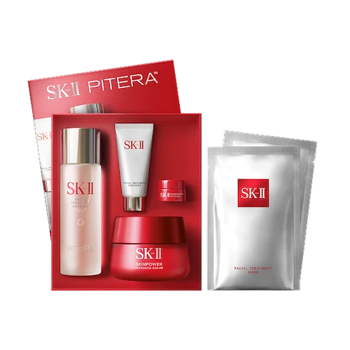 SK-II Pitera Anti-Aging Set with essence bottle, cream jar, cleanser tube, and sheet mask displayed beside an open red box