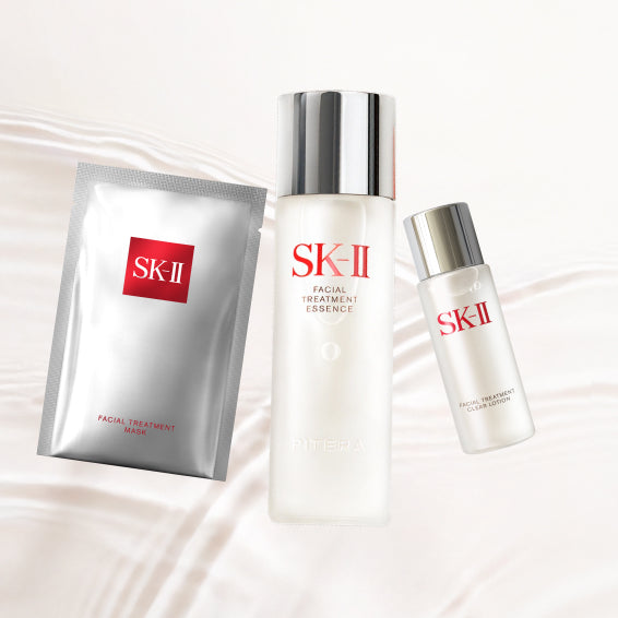 SK-II First Experience Kit displayed inside a red box with essence bottle, clear lotion, and sheet mask arranged neatly