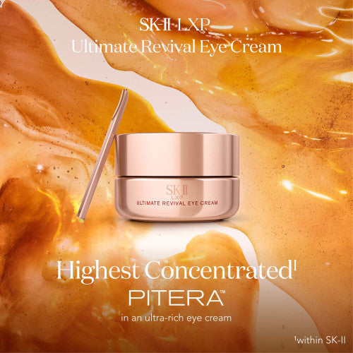 SK-II LXP Ultimate Revival Eye Cream jar with spatula placed beside it against flowing amber liquid backdrop