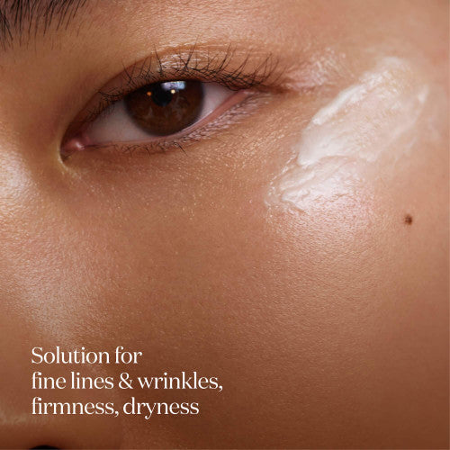 Close-up of eye area with SK-II LXP Ultimate Revival Eye Cream applied on outer cheek showing smooth cream texture