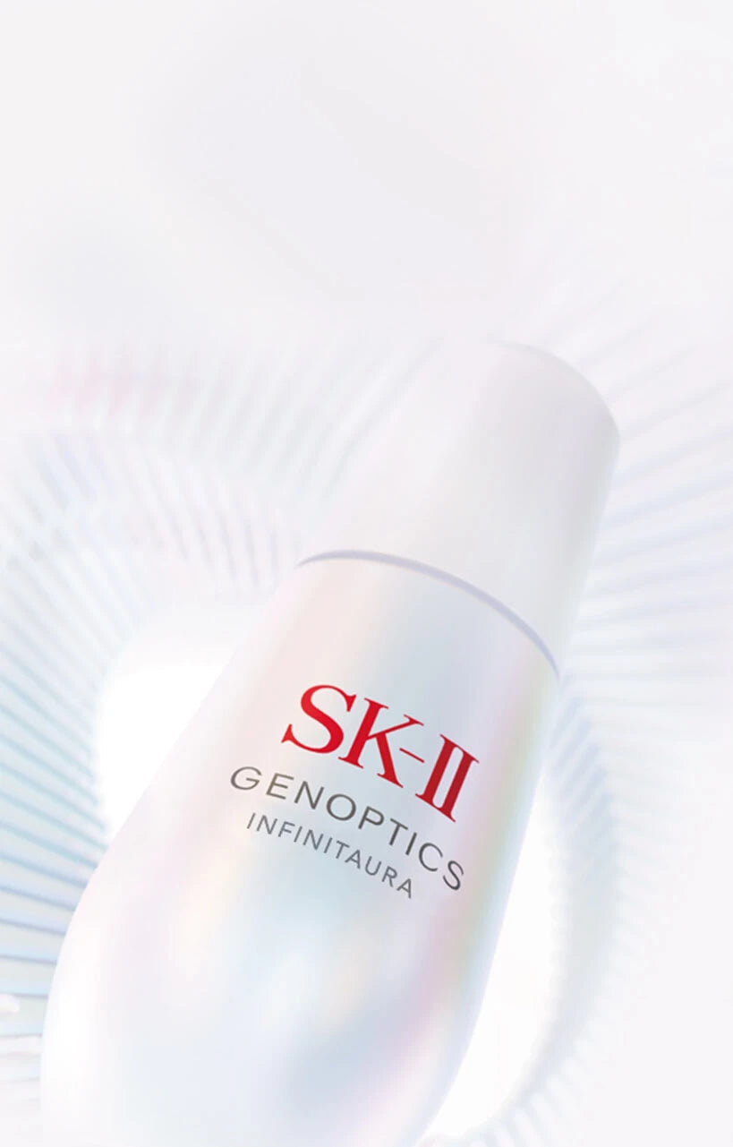 SK‑II GenOptics Infinitaura serum bottle on soft light background with circular radial pattern
 