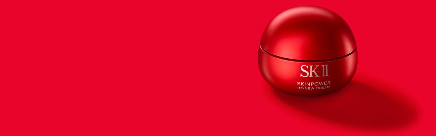 SK-II SKINPOWER Re-New Cream jar in red packaging placed on a solid red background with a soft shadow