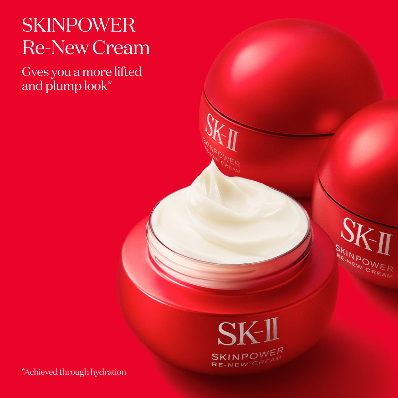 SK-II SKINPOWER Re-New Cream jar opened to show white cream with additional closed jars placed behind on a red background
